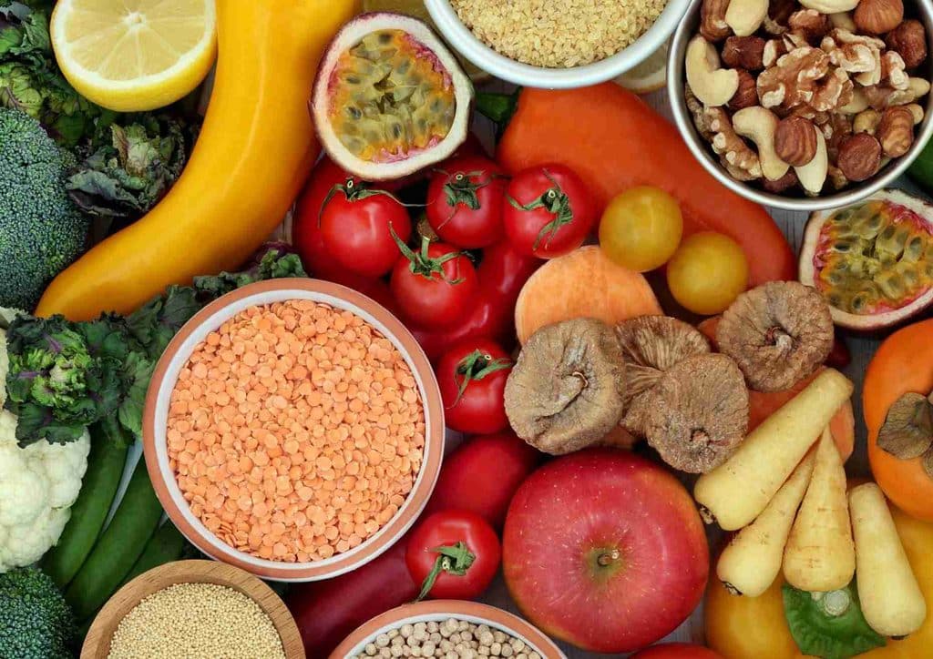High Fibre Diet for Weight Loss: Why Fibre Keeps You Full 34 Bowls filled with an array of fresh fruits and vegetables, highlighting their vibrant colours and diverse textures.