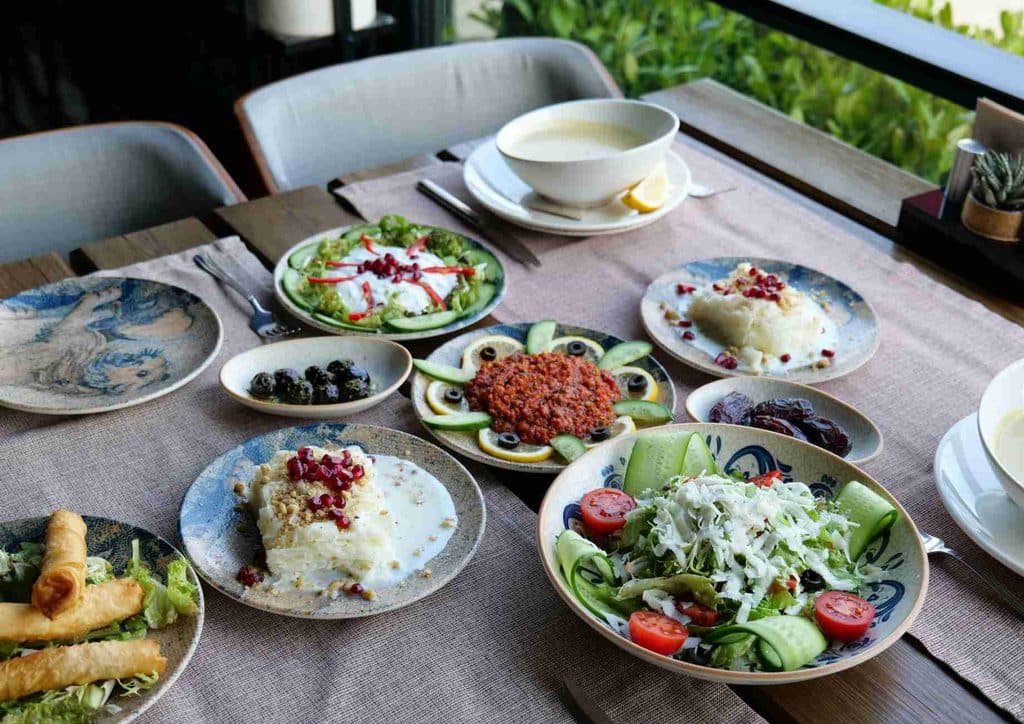 Is the Mediterranean Diet Good for Weight Loss? 18 A richly set table adorned with multiple dishes, highlighting an array of culinary delights and vibrant presentations.