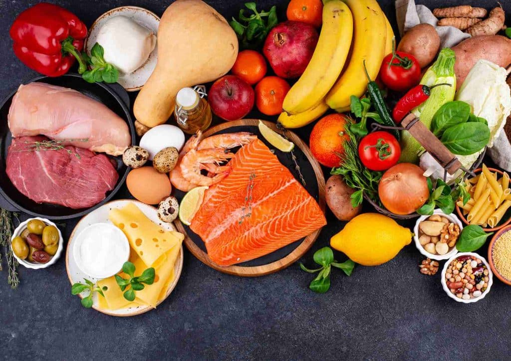 Is the Mediterranean Diet Good for Weight Loss? 20 A diverse spread of food items including fresh fish, vibrant vegetables, assorted fruits, and cuts of meat on display.