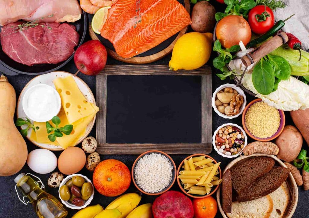 Is the Mediterranean Diet Good for Weight Loss? 22 A diverse assortment of foods featuring fish, eggs, vegetables, and various meats arranged on a table.