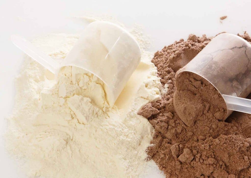 Is Whey Protein Good for Weight Loss? 37 A container of protein powder alongside a scoop of whey protein on a wooden surface.