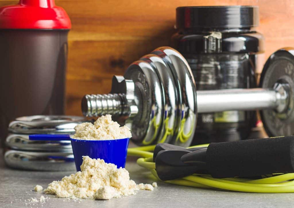 Is Whey Protein Good for Weight Loss? 27 A collection of fitness equipment and supplements, including weights, resistance bands, and protein powders, arranged neatly.