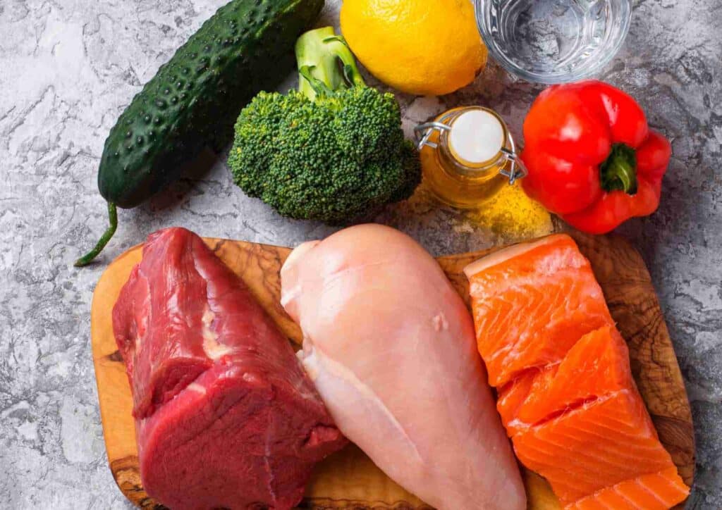 Keto vs Low Carb for Weight Loss: Which Is Better? 13 An assortment of heart-friendly foods such as avocados, berries, and leafy greens arranged on a kitchen countertop.