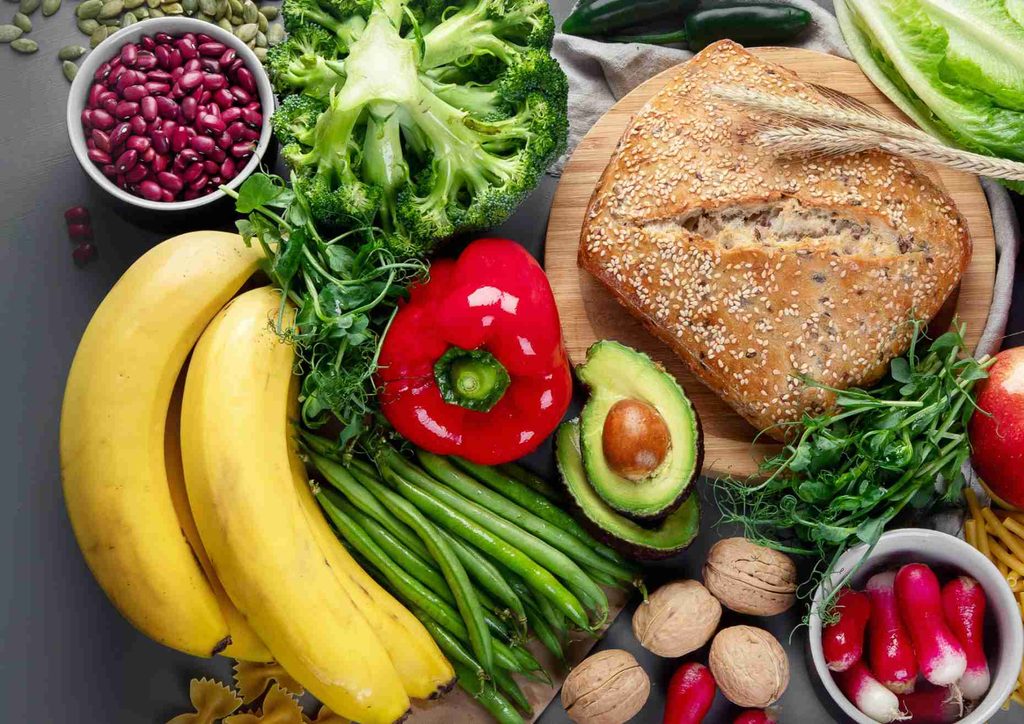 Keto vs Low Carb for Weight Loss: Which Is Better? 49 A diverse selection of fresh fruits and vegetables neatly arranged on a table, highlighting their natural beauty and variety.