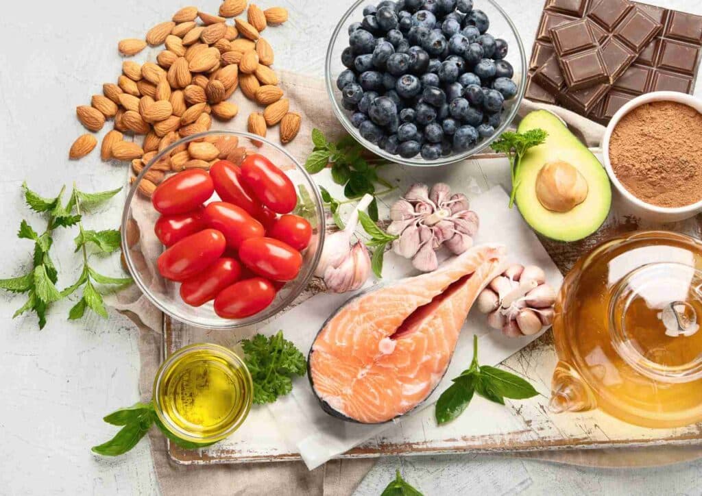 Keto vs Low Carb for Weight Loss: Which Is Better? 32 A variety of heart-healthy foods including fruits, vegetables, nuts, and whole grains displayed on a wooden table.