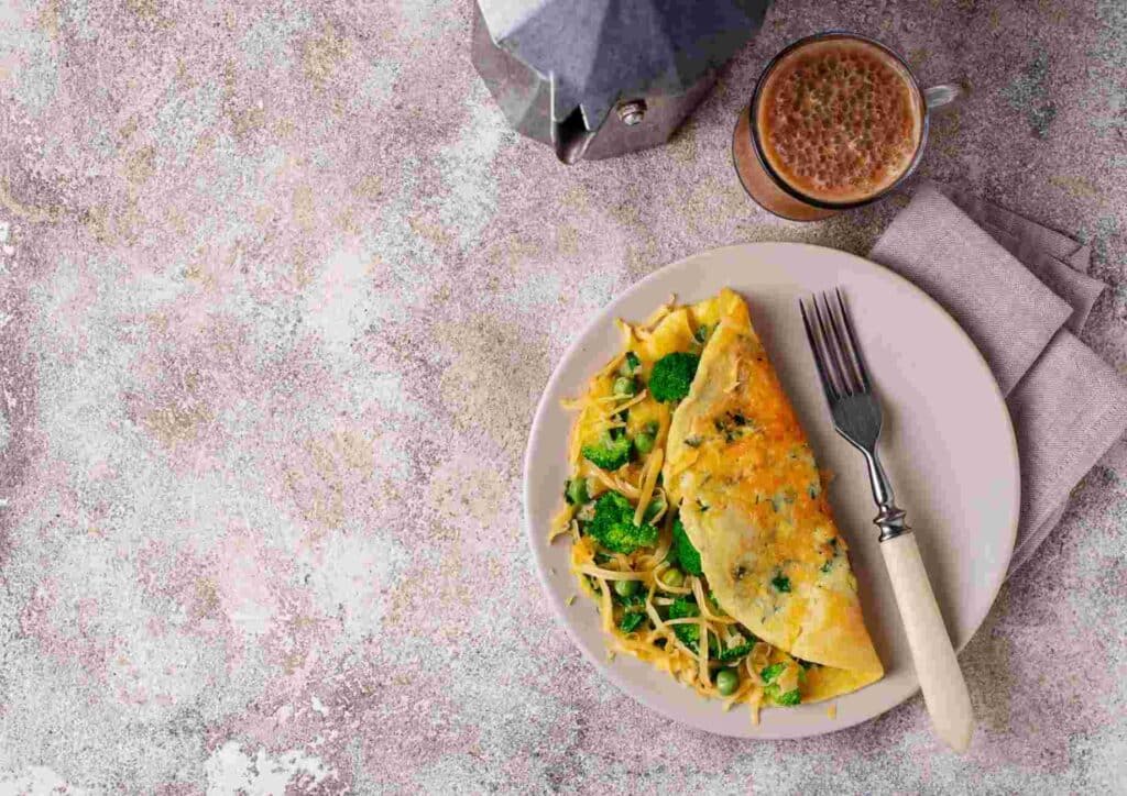 Keto vs Low Carb for Weight Loss: Which Is Better? 34 A plate featuring a fluffy omelette accompanied by a fork resting beside it.