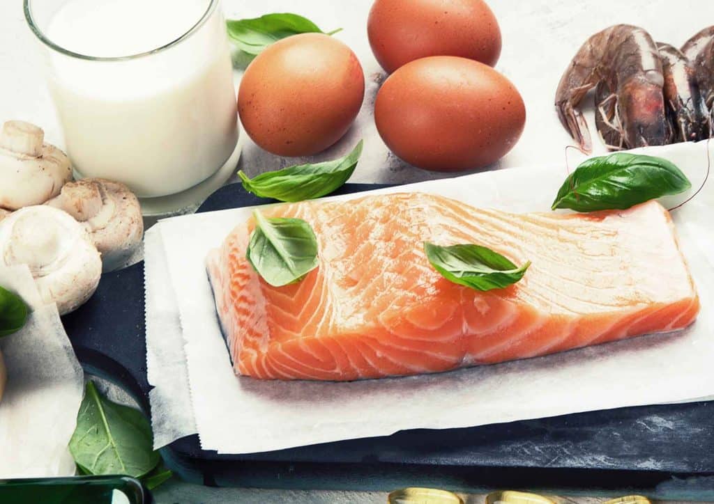Keto vs Low Carb for Weight Loss: Which Is Better? 48 A table set with various foods, including fish, eggs, and additional dishes, arranged for a meal.