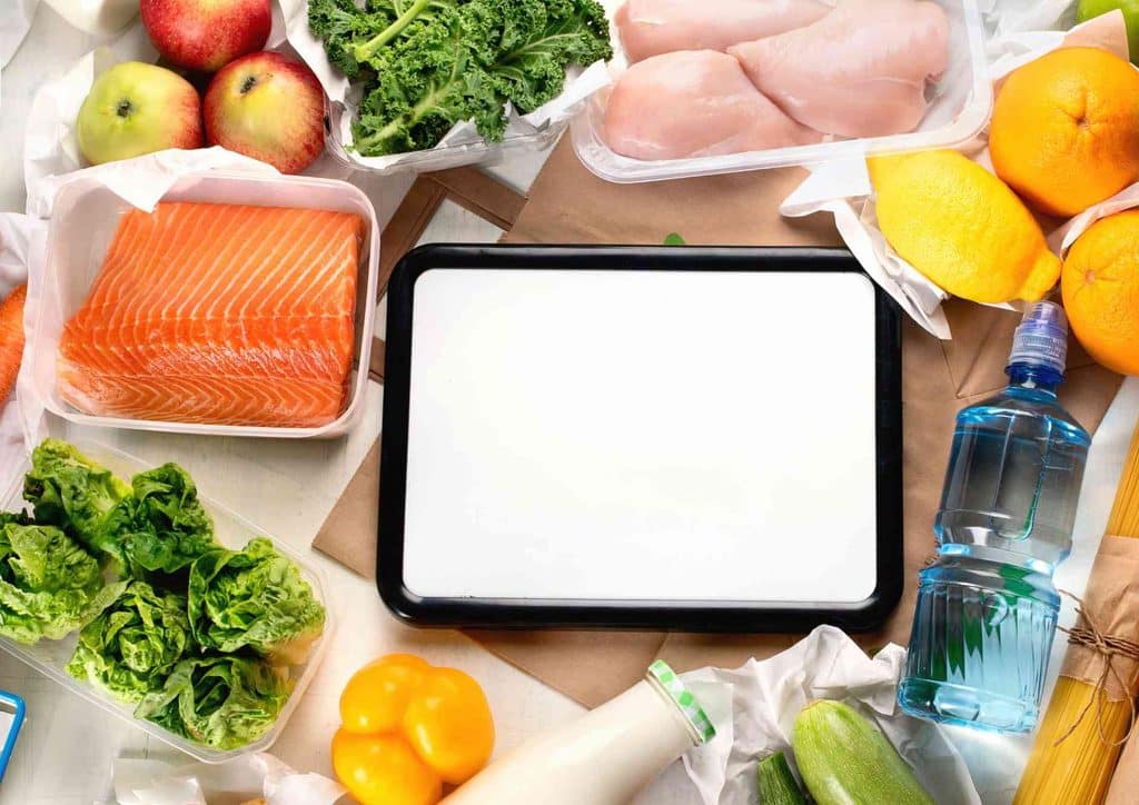 Keto vs Low Carb for Weight Loss: Which Is Better? 44 A white square with a blank screen is surrounded by various food items, creating a vibrant and inviting scene.