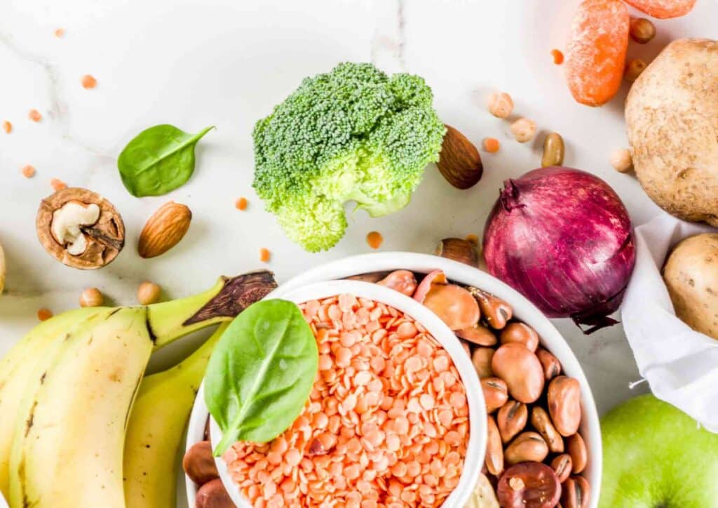 Keto vs Low Carb for Weight Loss: Which Is Better? 50 A vibrant bowl containing assorted vegetables, fresh fruits, and mixed nuts, showcasing healthy food options.