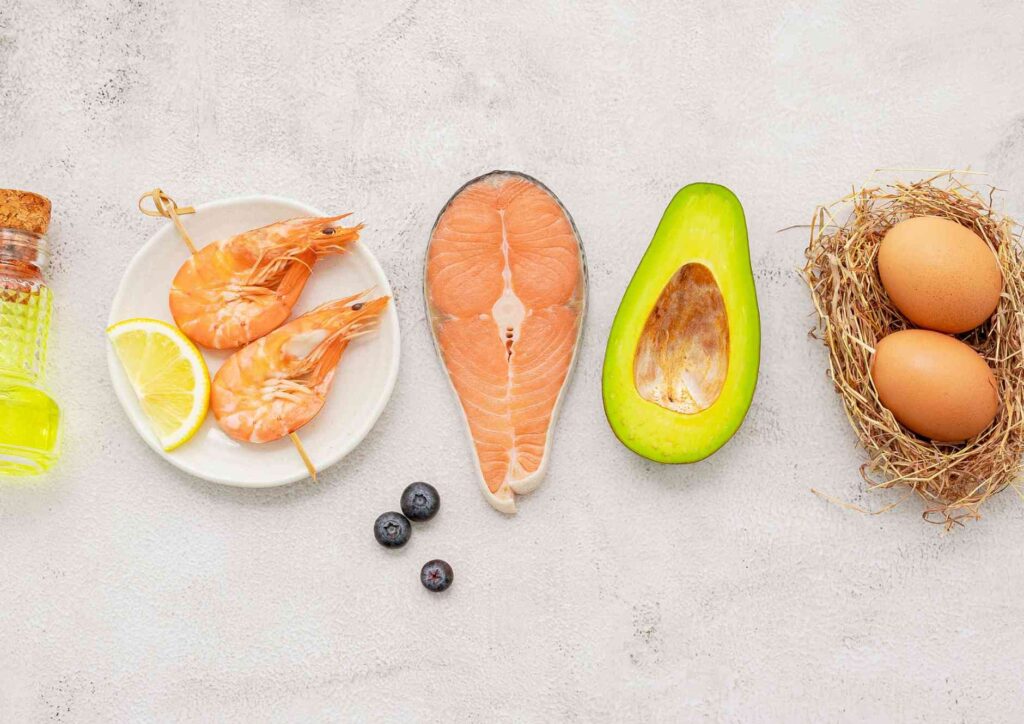 Keto vs Low Carb for Weight Loss: Which Is Better? 38 An assortment of heart-friendly foods such as avocados, berries, and leafy greens arranged on a rustic surface.