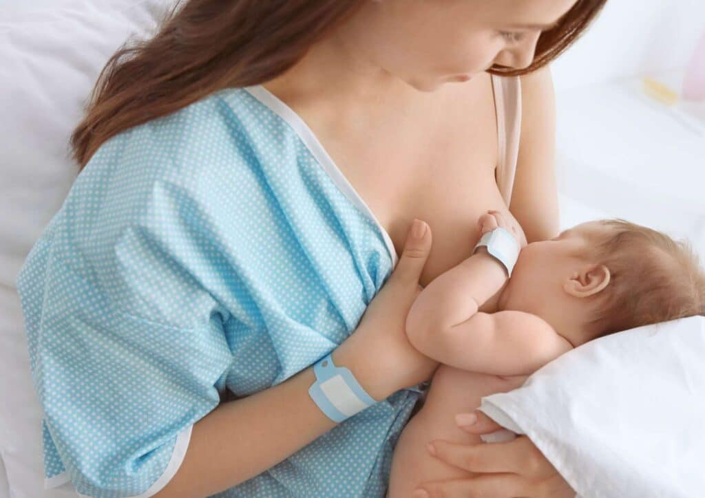Losing Weight While Breastfeeding: What's Safe and Realistic 65 reastfeeding mother cradles her baby, emphasising the importance of breastfeeding for infant health and bonding.