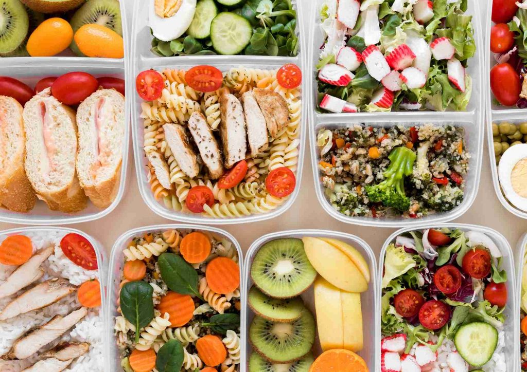 Healthy Lunches for Weight Loss: Work and Home Ideas 24 A selection of diverse foods arranged in clear plastic containers, showcasing various colours and textures.
