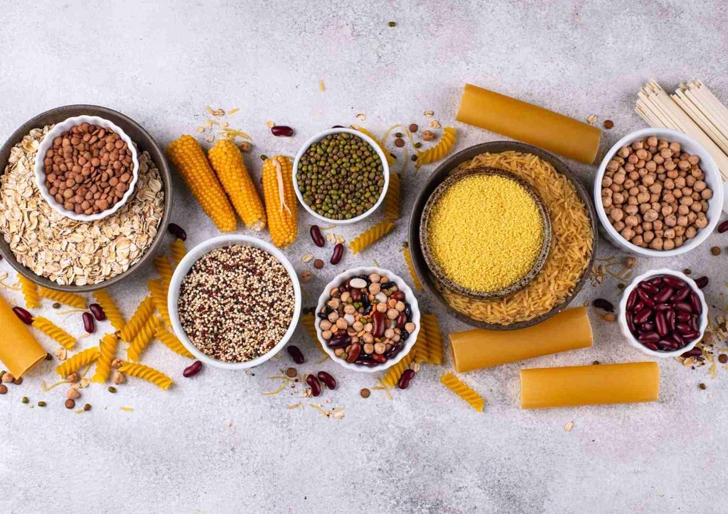 High Fibre Diet for Weight Loss: Why Fibre Keeps You Full 26 Various grains, beans, and nuts displayed in bowls, highlighting their different shapes and hues.
