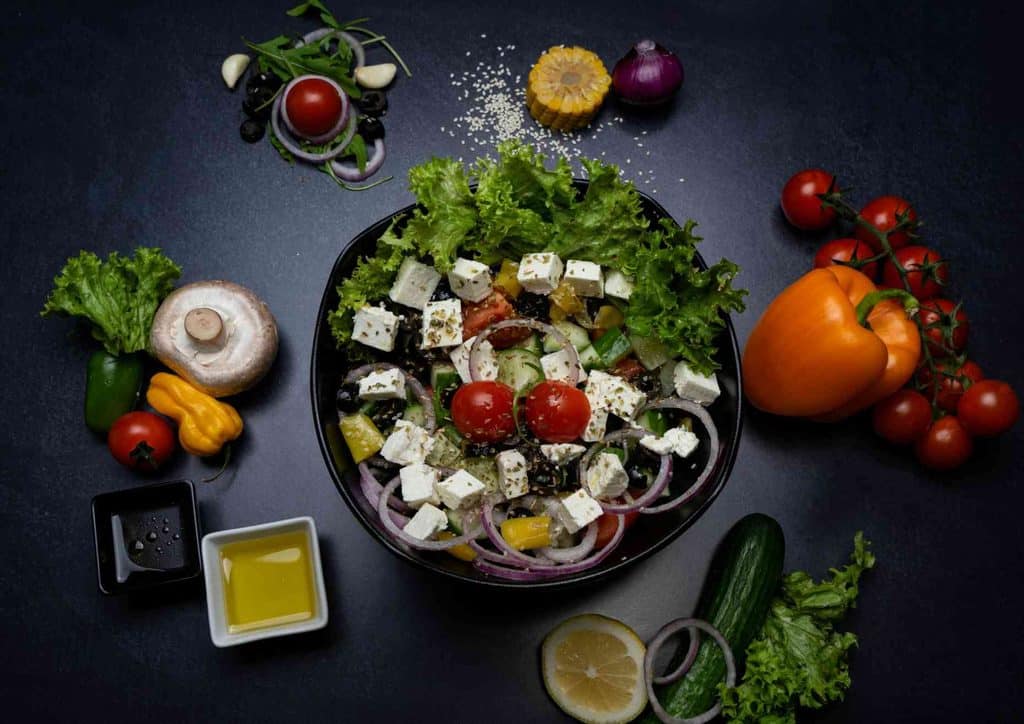 Is the Mediterranean Diet Good for Weight Loss? 37 A bowl of Greek salad featuring tomatoes, cucumbers, olives, feta cheese, and a drizzle of olive oil.