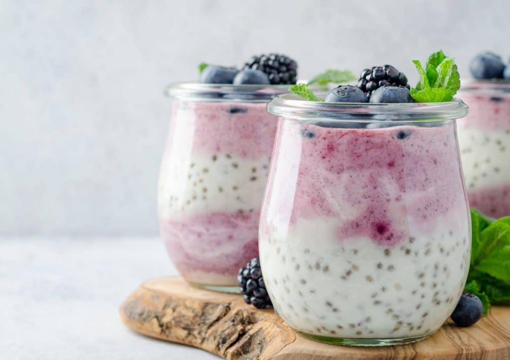 Is the Mediterranean Diet Good for Weight Loss? 25 Blueberry chia pudding served in glass jars, arranged on a rustic wooden board.