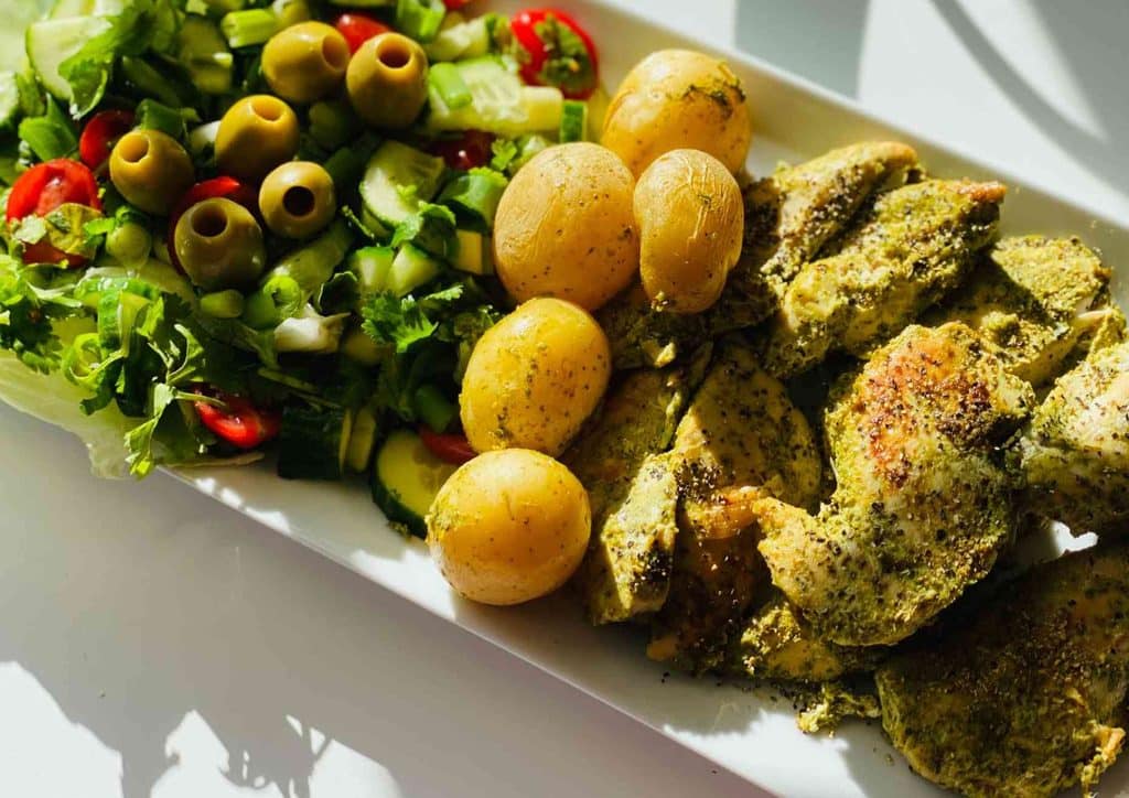 Is the Mediterranean Diet Good for Weight Loss? 17 A plate featuring grilled chicken, roasted potatoes, and a fresh garden salad.