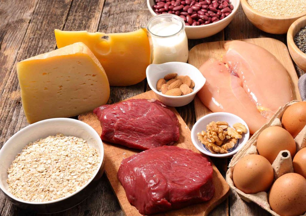 Postpartum Weight Loss: A Gentle, Realistic Guide 18 A variety of heart-healthy foods including fruits, vegetables, whole grains, and nuts displayed on a wooden table.