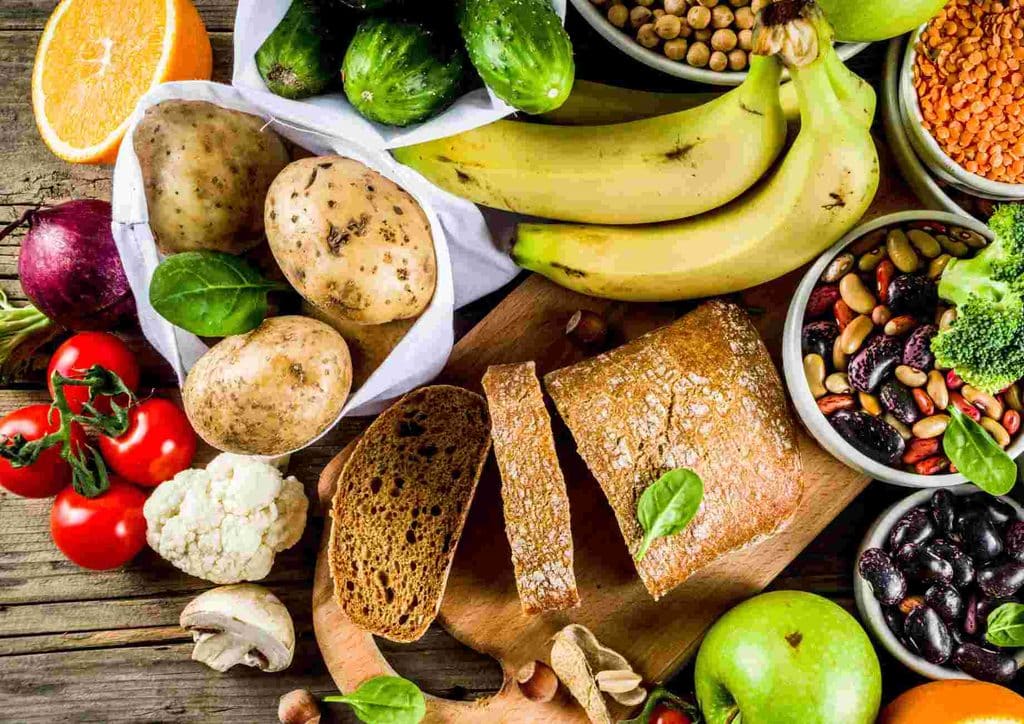 Postpartum Weight Loss: A Gentle, Realistic Guide 19 Bowls filled with an array of fresh fruits and vegetables, highlighting their vibrant colours and diverse textures.