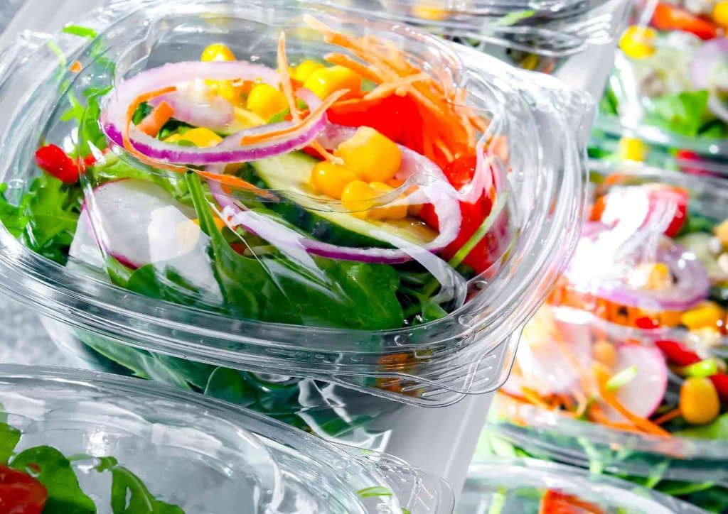 Easy Meals for Weight Loss When You're Short on Time 31 Close-up of fresh salad in clear plastic containers, showcasing vibrant greens and colourful vegetables.