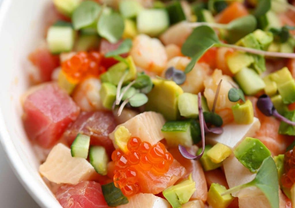 Easy Meals for Weight Loss When You're Short on Time 26 A bowl containing shrimp, sliced avocado, and cucumber arranged attractively.