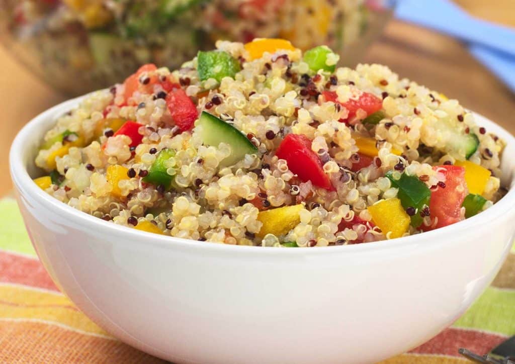 Vegetarian Diet for Weight Loss: How to Get It Right 30 A vibrant quinoa salad in a bowl, filled with assorted fresh vegetables and herbs.
