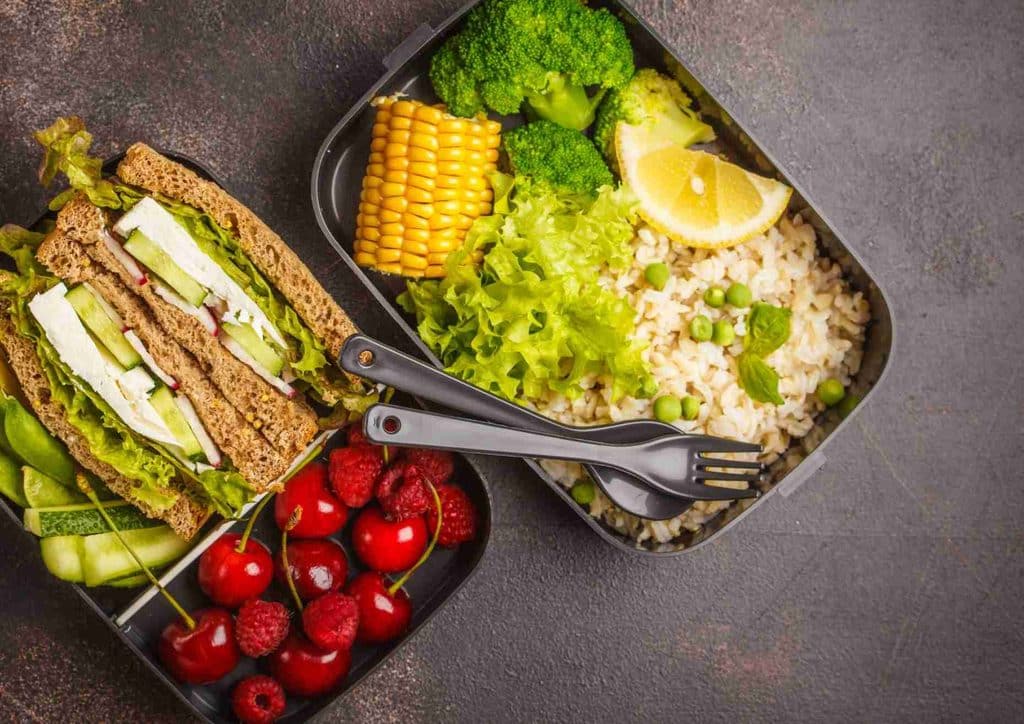 Healthy Dinners for Weight Loss: Easy Weeknight Ideas 34 A lunch box containing a sandwich, a side salad, and assorted fresh fruit.