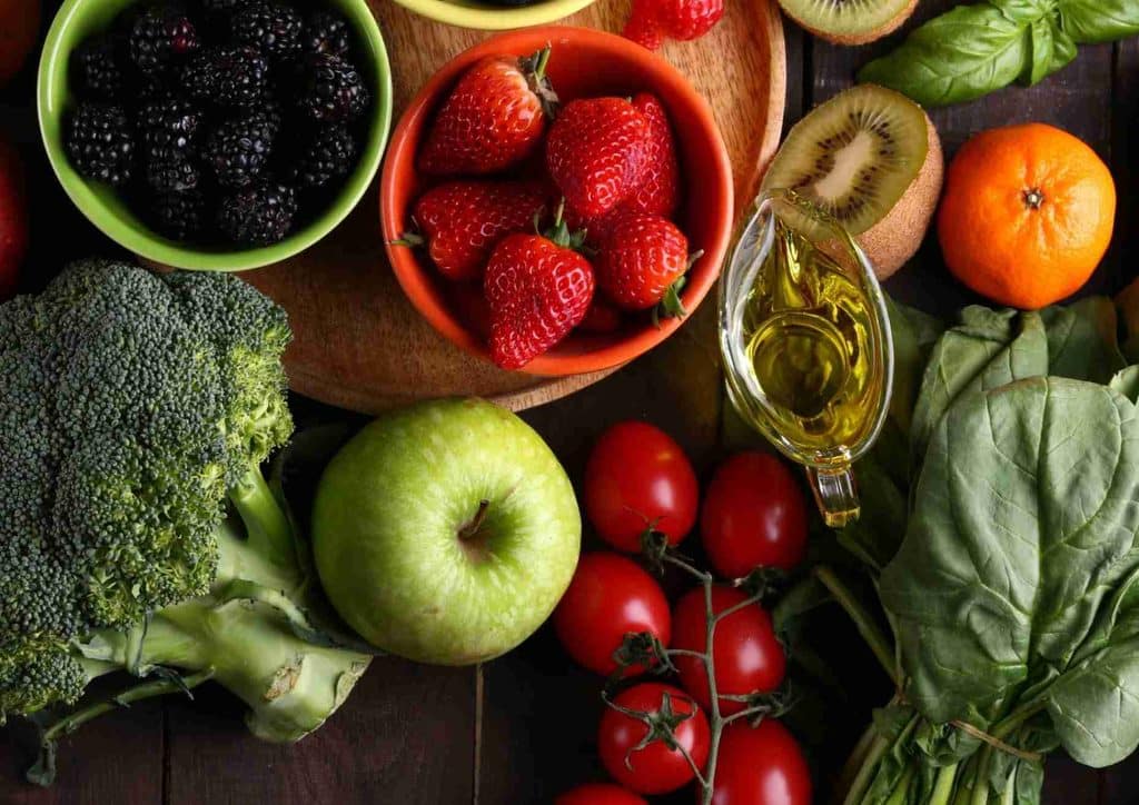High Fibre Diet for Weight Loss: Why Fibre Keeps You Full 21 A diverse selection of fresh fruits and vegetables neatly arranged on a table, highlighting their natural beauty and variety.