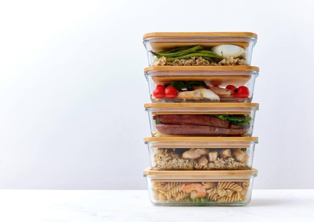 Healthy Meal Plans for Weight Loss: How to Build One That Lasts 4 A stack of four food containers, each filled with different types of food, arranged neatly on a surface.