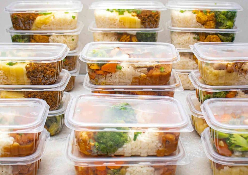 Healthy Meal Plans for Weight Loss: How to Build One That Lasts 6 A collection of numerous plastic containers filled with various types of food, arranged neatly on a table.
