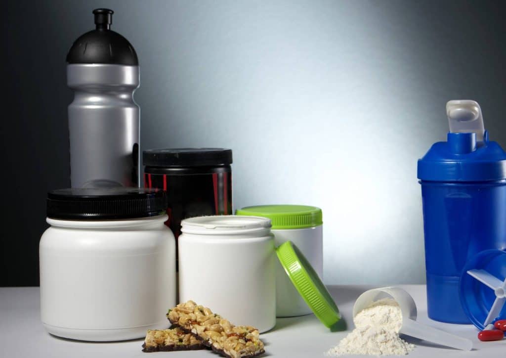 Is Whey Protein Good for Weight Loss? 23 A variety of protein supplements, including powders, bars, and shakes, displayed on a wooden surface.