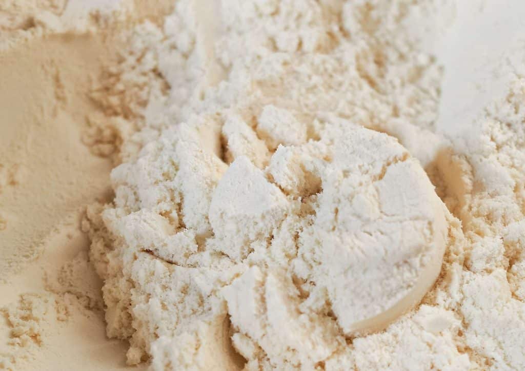 Is Whey Protein Good for Weight Loss? 22 Close-up of a bowl filled with white flour, showcasing its fine texture and powdery appearance.