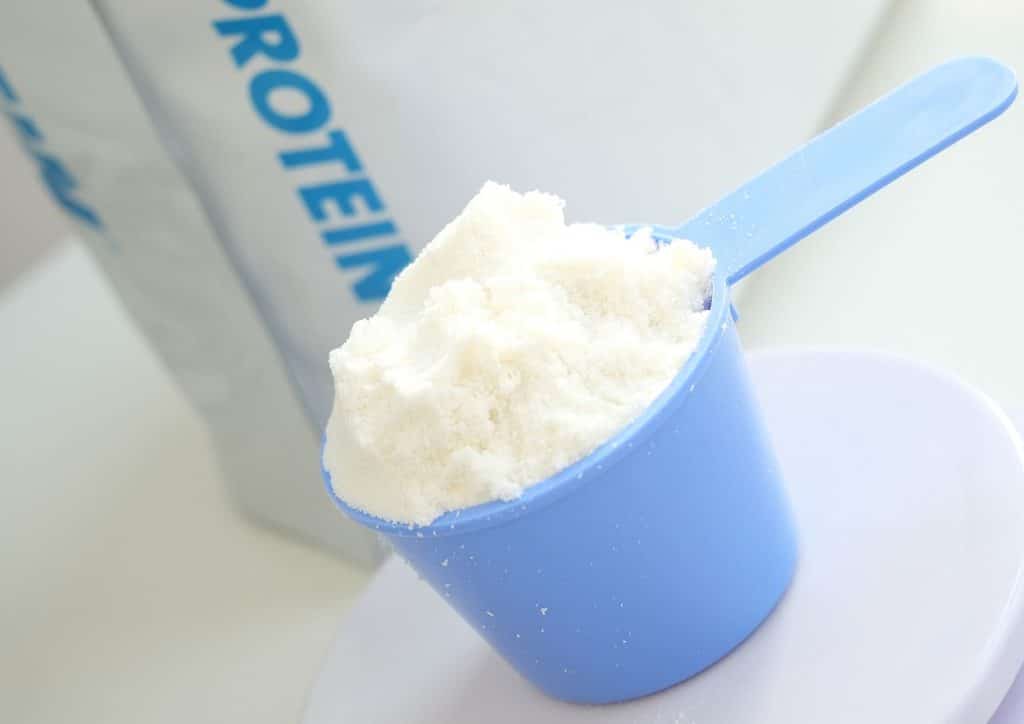 Is Whey Protein Good for Weight Loss? 21 Protein powder in a blue cup, showcasing a smooth texture and rich colour, ready for mixing or consumption.