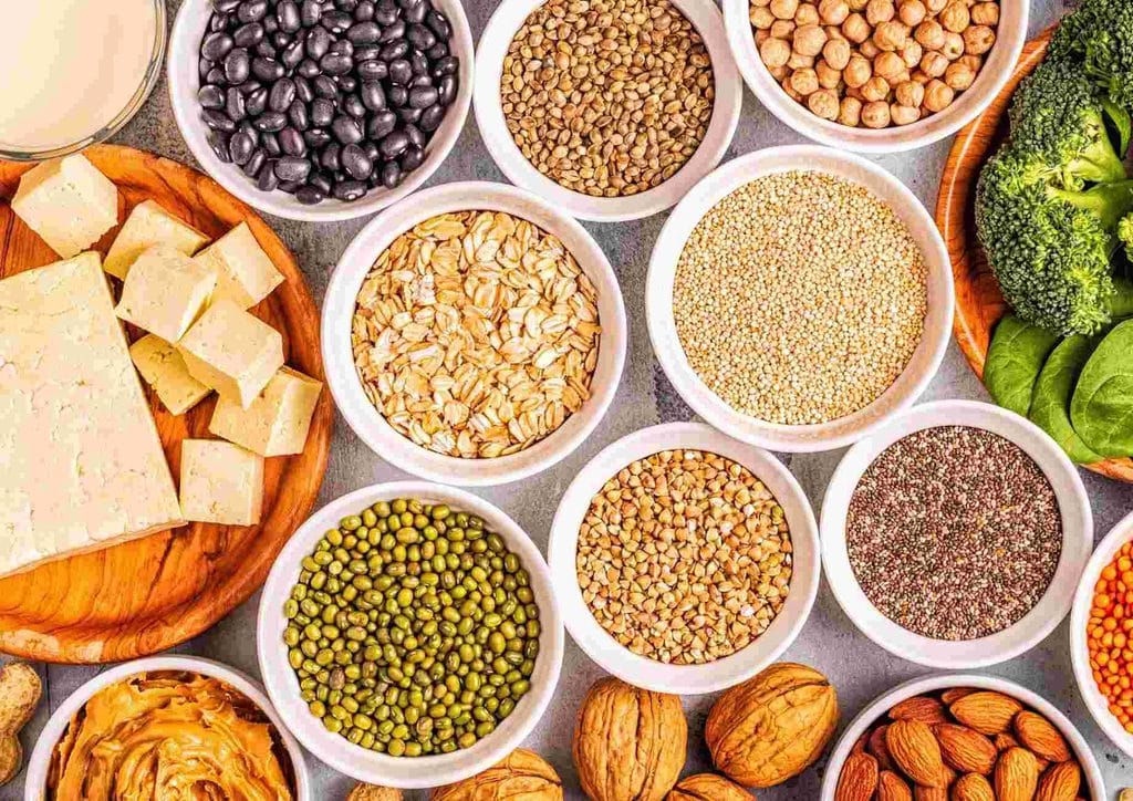 Vegetarian Diet for Weight Loss: How to Get It Right 43 An assortment of foods including nuts, beans, and grains displayed on a wooden surface.