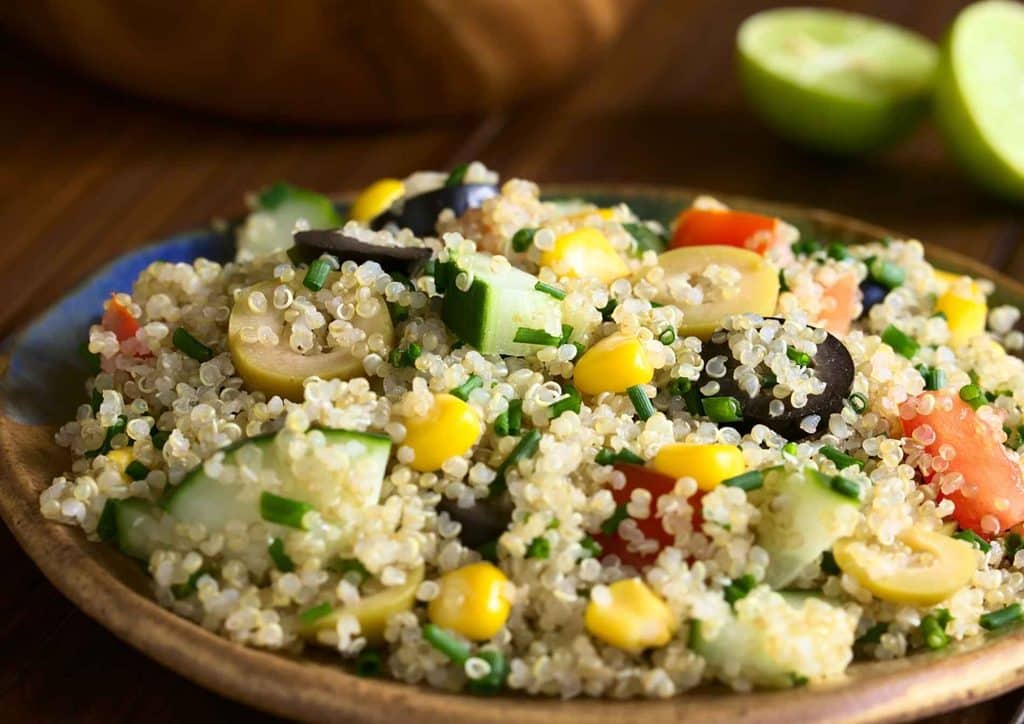 Vegetarian Diet for Weight Loss: How to Get It Right 48 Quinoa salad in a bowl, mixed with vibrant vegetables and sweet apple pieces, showcasing a healthy meal option.