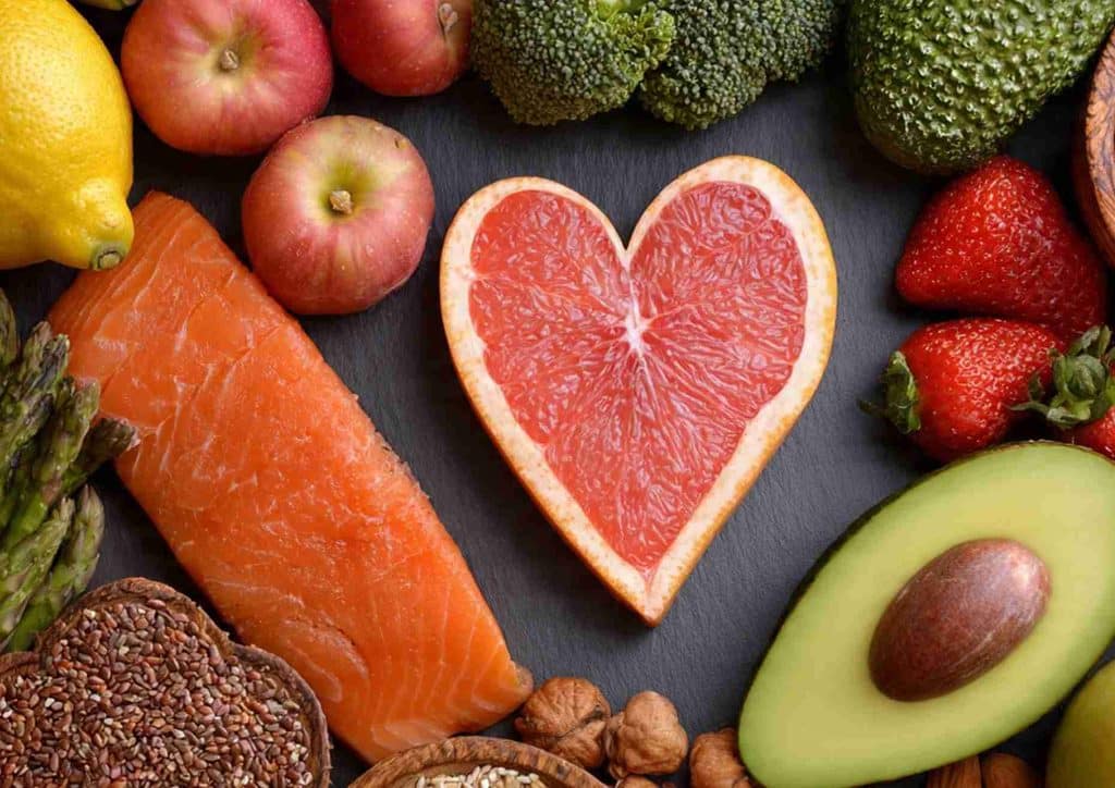 Losing Weight While Breastfeeding: What's Safe and Realistic 29 Heart-shaped food centerpiece with an array of fruits and vegetables arranged around it, highlighting healthy eating.