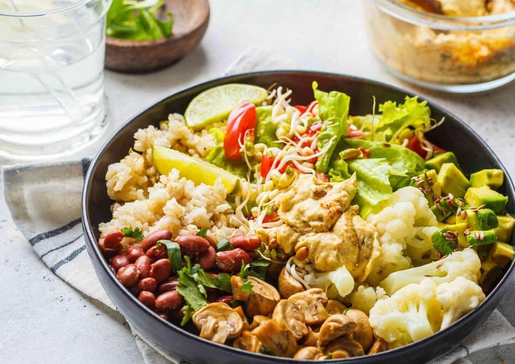 Healthy Lunches for Weight Loss: Work and Home Ideas 8 A vibrant bowl containing rice, beans, mixed vegetables, and additional ingredients, representing a wholesome dish.