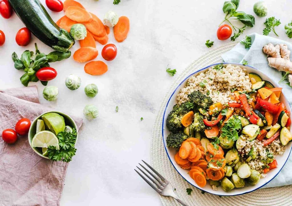 Healthy Lunches for Weight Loss: Work and Home Ideas 2 A serving of rice topped with assorted vegetables, with a fork placed beside the plate.