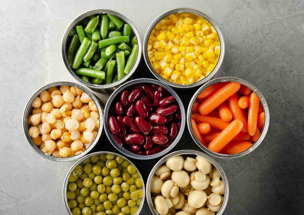 Easy Meals for Weight Loss When You're Short on Time 2 A circular arrangement of assorted canned vegetables, showcasing various types and colours of produce.
