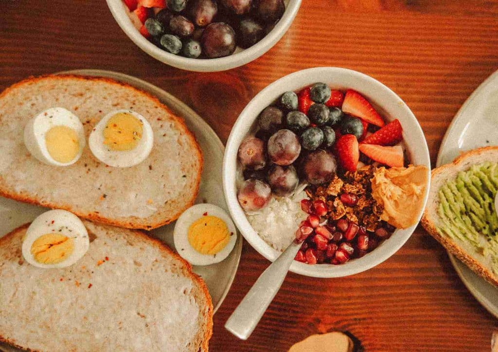 Postpartum Weight Loss: A Gentle, Realistic Guide 16 A table displaying various bowls of food alongside several eggs, arranged for a meal setting.