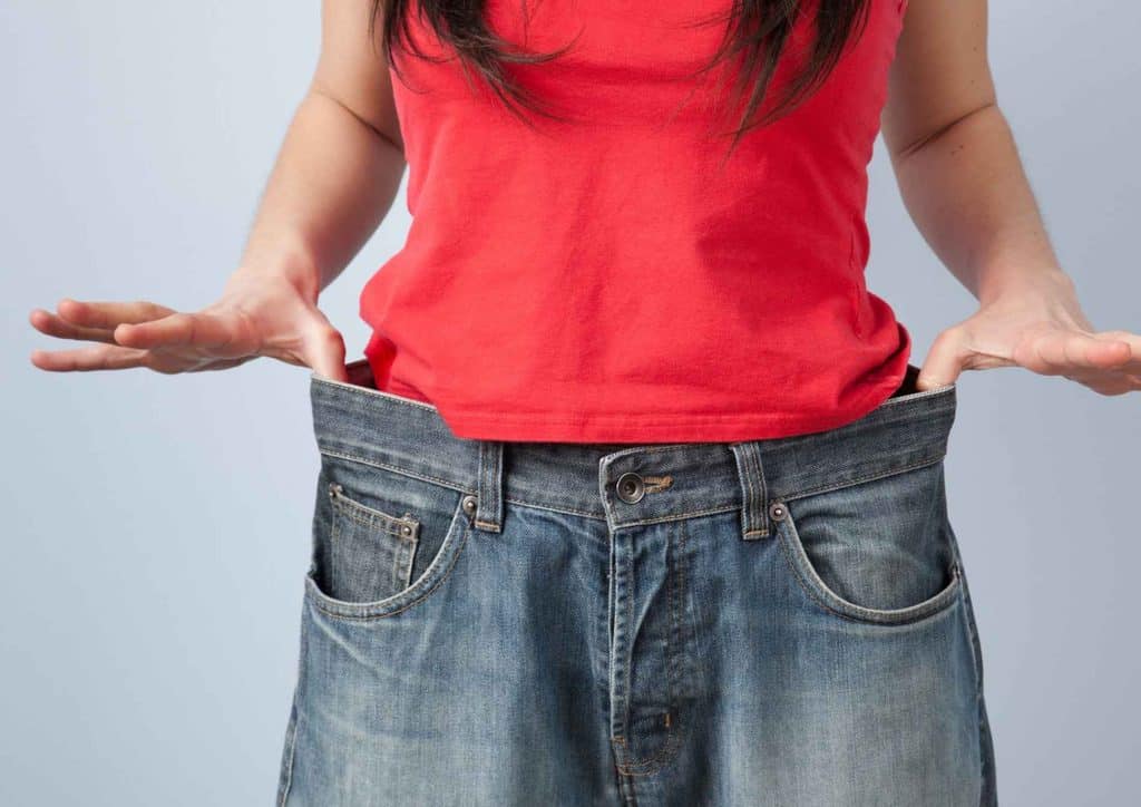 Losing Weight While Breastfeeding: What's Safe and Realistic 13 A woman poses confidently, showcasing her stylish jeans in a casual setting.
