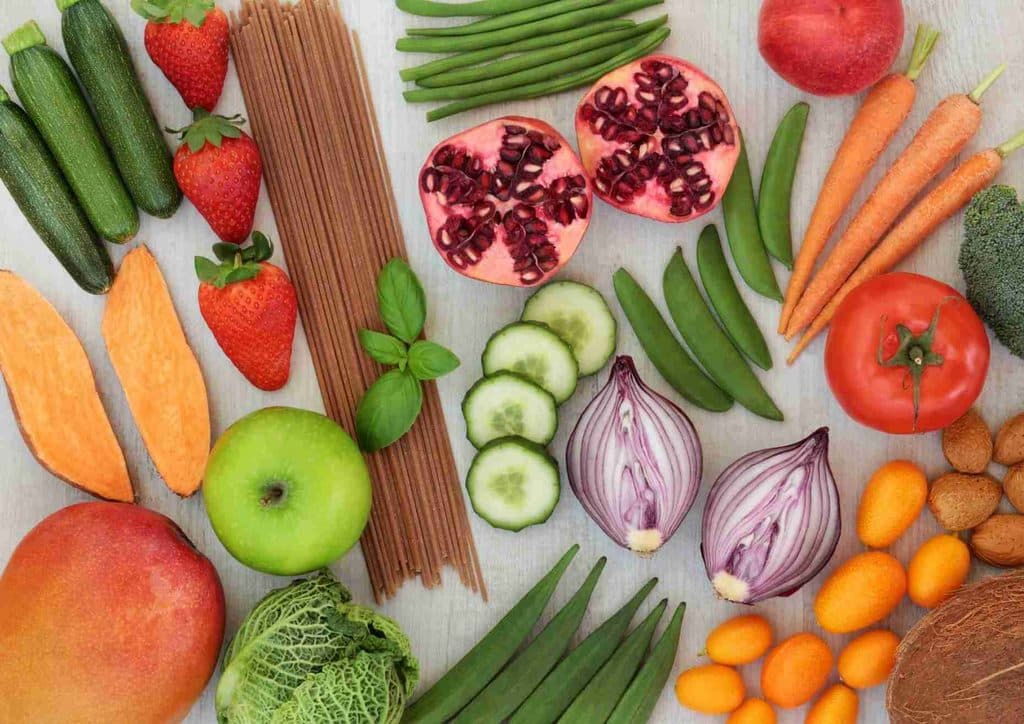 High Fibre Diet for Weight Loss: Why Fibre Keeps You Full 3 A diverse selection of fresh fruits and vegetables neatly arranged on a table, highlighting their natural beauty and variety.
