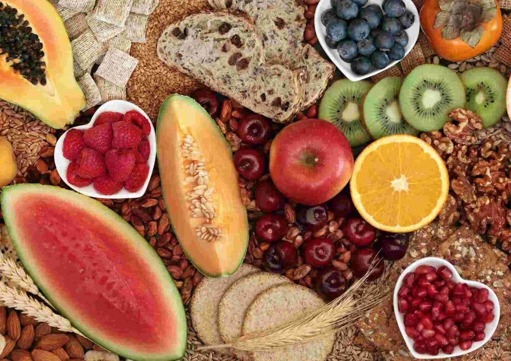High Fibre Diet for Weight Loss: Why Fibre Keeps You Full 1 A colourful assortment of fruits and vegetables displayed in bowls, showcasing a variety of shapes and colours.